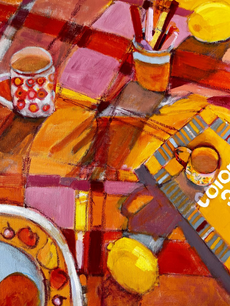 Still life painting of cup, book, mug, pot of paint brushes, lemon and orange in bowl